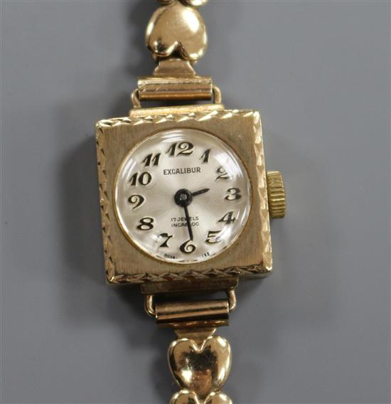 A ladys 9ct gold Excalibur manual wind wrist watch, on a 9ct gold bracelet.